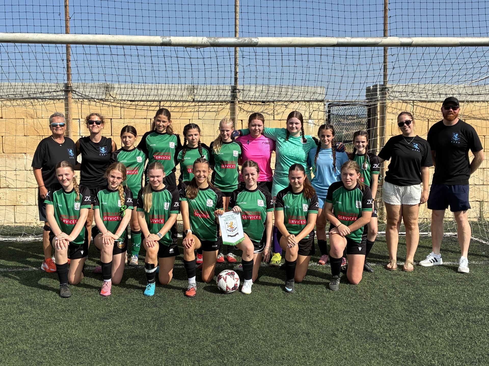 Students standing together for a team shot in Malta