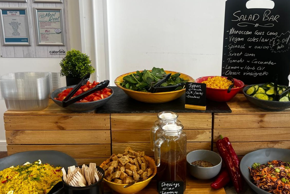 The Ribston Kitchen's salad bar - bowls of freshly prepared salad and a menu board with what is on offer that day.